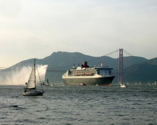 QM2 Fireboat splashes water in greeting