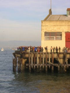 welcoming crowd on pier at Fort Mason