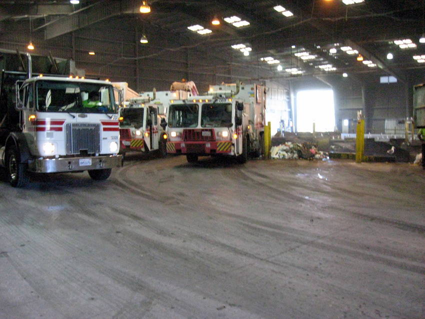 garbage trucks dumping loads